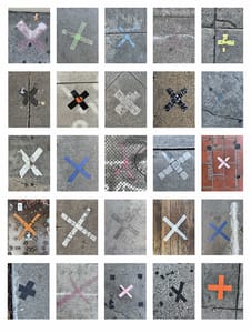 A collage of different colored x's on the sidewalk.