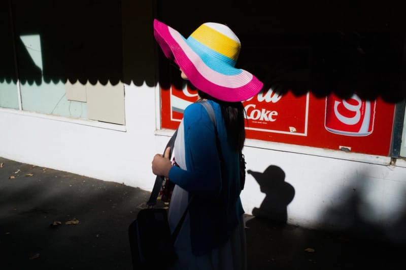 Street photography of a Lady wearing a rainbow hat